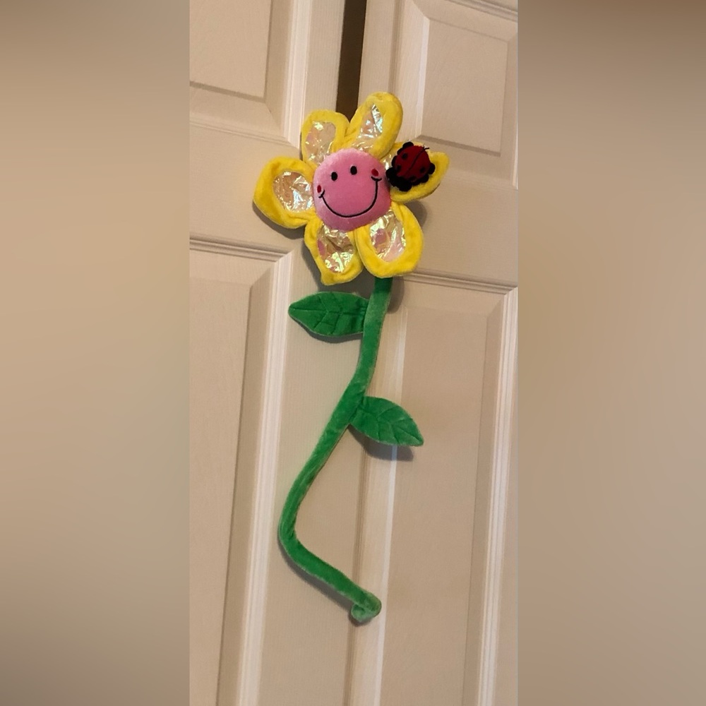 Plush stroller toy easily wraps around handles of stroller or car seat.